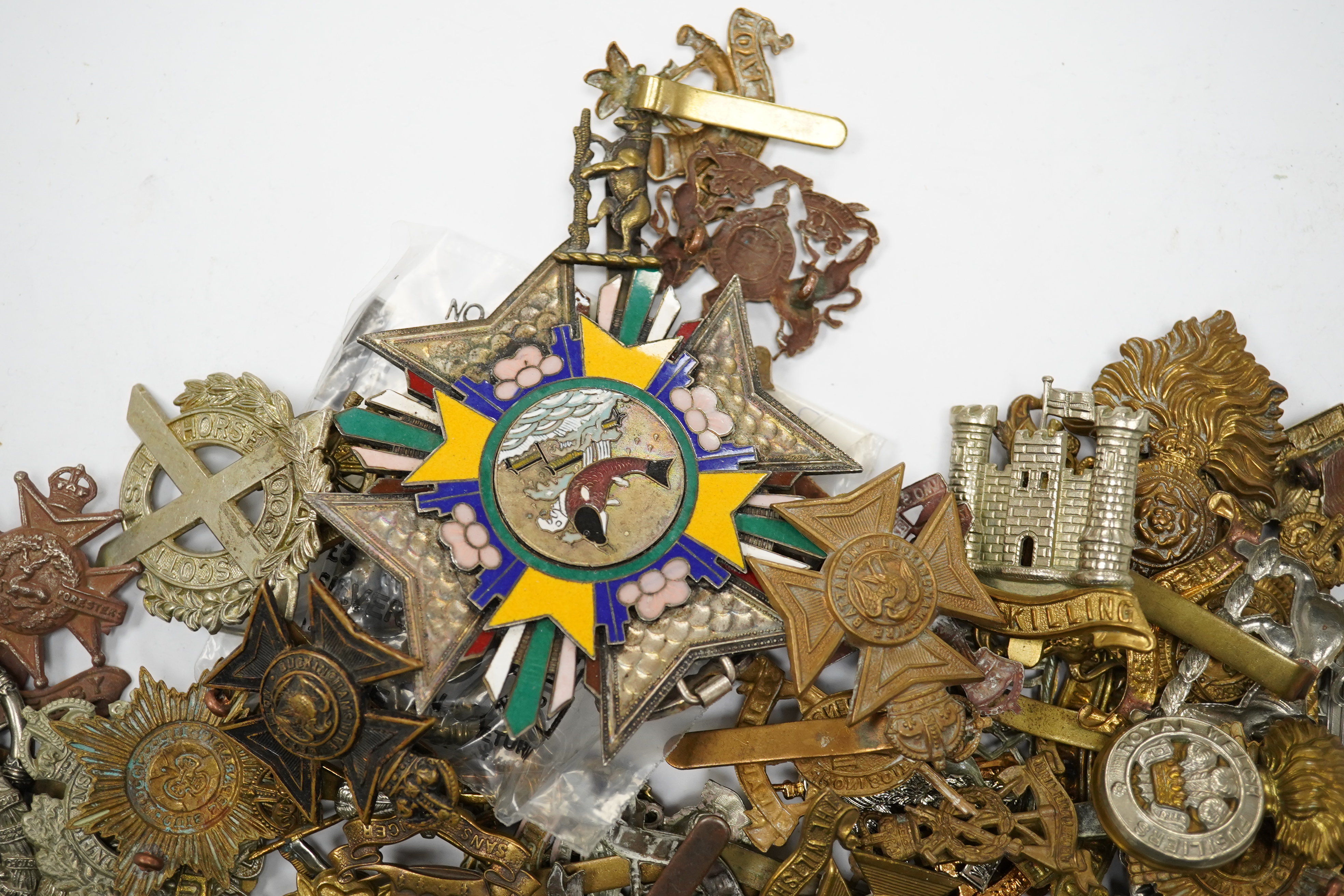 Seventy-eight military cap badges, including; the Royal Horse Artillery, the King’s Own, the Notts and Derby Regiment, the Royal Hussars, the Shropshire Yeomanry, the Herefordshire Regiment, the City of London Volunteer